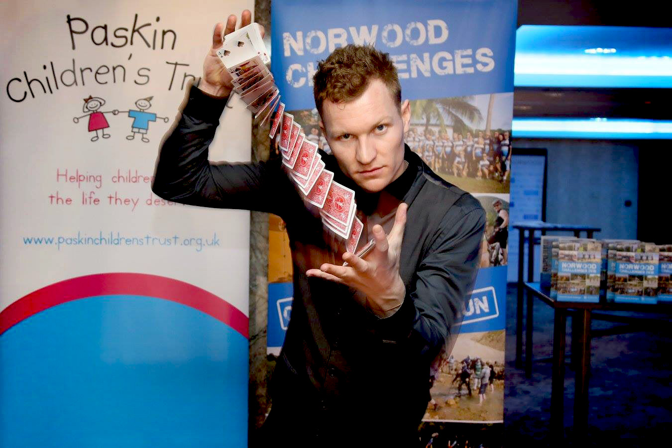Street Magician Liam Walsh performing close up magic at Norwood Charity Boxing Night in London